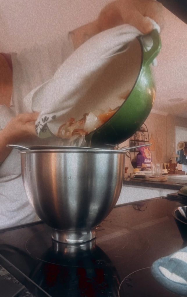 Green pot filled with onions being poured into a bowl